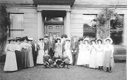 People outside a building wearing hats