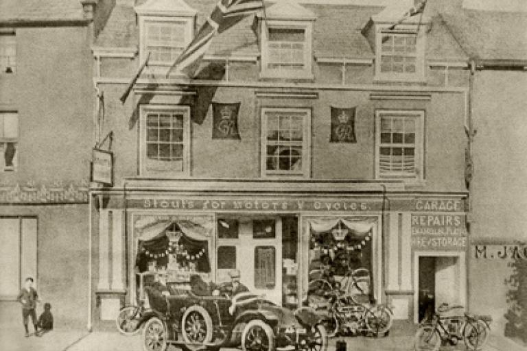 Old car in front of a car showroom