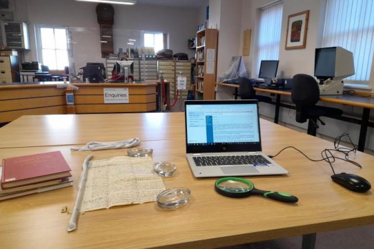 Deed, laptop and research guides